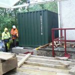 The first container in place in pouring rain