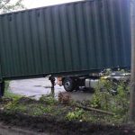 The container is swung into position